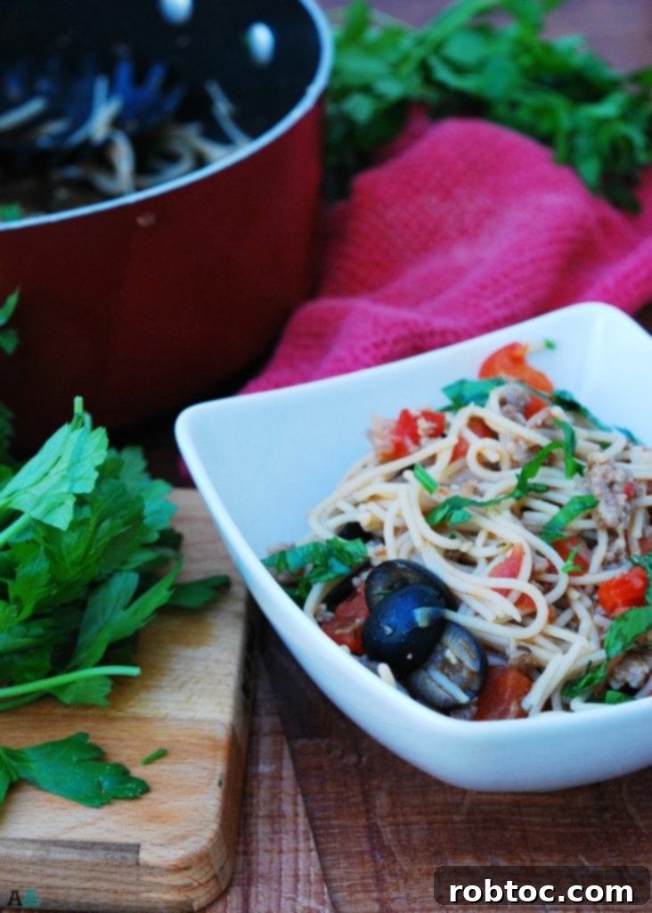Serving of 30-Minute Gluten-Free Sausage and Peppers Pasta garnished with fresh parsley