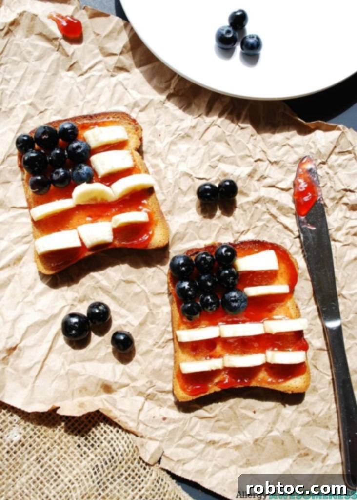 Red, White & Blue Allergy-Friendly Toast 2 Patriotic Toast featuring two slices adorned with blueberries, bananas, and strawberry jam, creating a vibrant red, white, and blue flag design. The toast is gluten-free, dairy-free, egg-free, soy-free, peanut-free, and tree nut-free, making it suitable for multiple allergies.