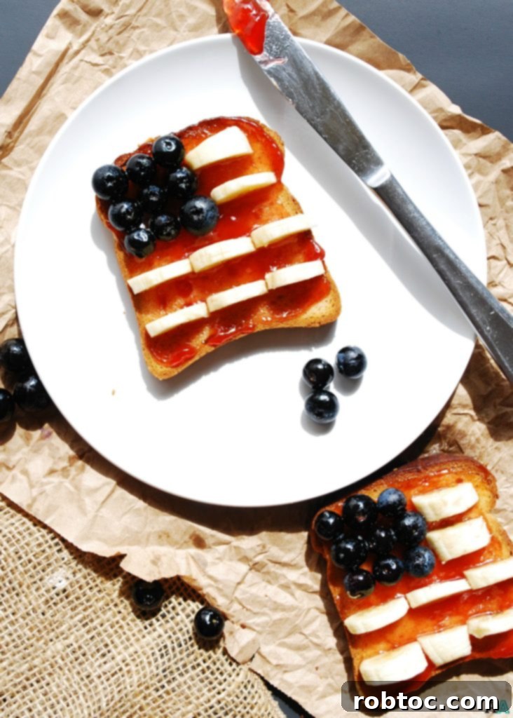 Red, White & Blue Allergy-Friendly Toast 6 Overhead view of a beautifully prepared Patriotic Toast, perfect for an allergy-friendly breakfast. The red, white, and blue design is created with strawberry jam, banana slices, and blueberries on a gluten-free and top-8 free slice of toast.