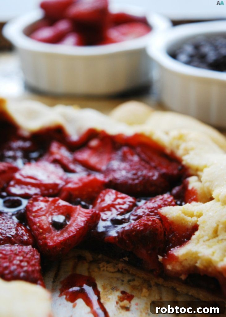 Vegan Top 8 Allergen-Free Strawberry Chocolate Galette 2 Close-up of a rustic Strawberry Chocolate Galette, golden brown cornmeal crust, melted chocolate pockets, and fresh strawberries, perfect for a gluten-free and vegan dessert.