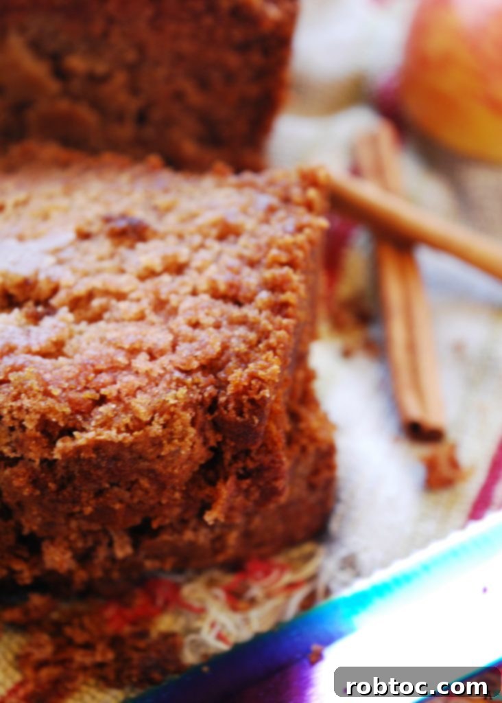 Freshly baked Applesauce Quick Bread cooling on a rack, showcasing its golden brown topping. A perfect gluten-free and vegan treat.