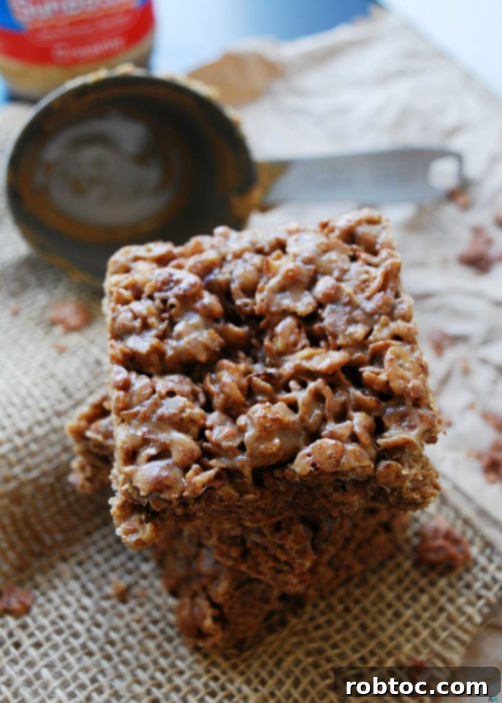Close-up of a stack of Inside Out Scotcheroos, highlighting their crispy, chewy texture and the rich chocolate and SunButter flavor. These bars are a perfect allergy-friendly dessert or snack.
