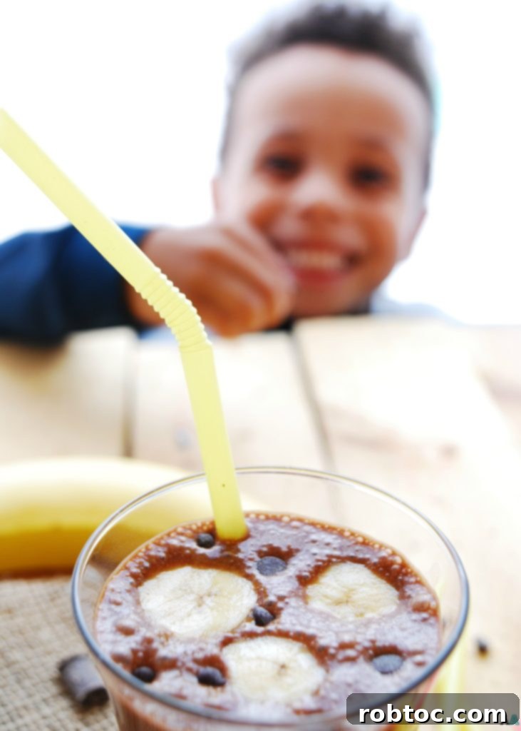 Allergen Free Vegan Chocolate Banana SunButter Breakfast Shake 4 My son reaching for chocolate chips garnishing a Chocolate Banana SunButter Breakfast Shake, highlighting how irresistible this gluten-free, dairy-free, egg-free, soy-free, peanut-free, tree nut-free, and vegan recipe is for kids. A perfect top 8 allergen-free treat!