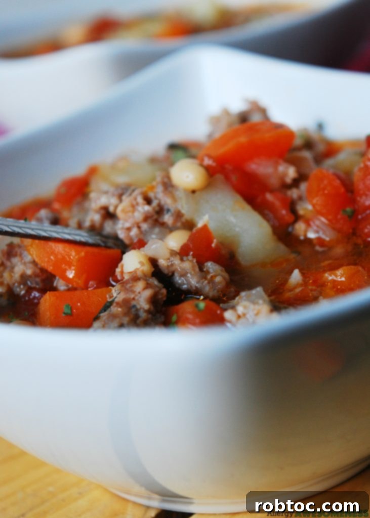 Bowl of comforting Potato & Sausage Soup, perfect for a cold day. Gluten-free, dairy-free.