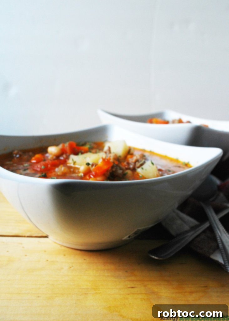 Bowl of homemade Gluten-Free and Dairy-Free Potato & Sausage Soup ready to be served.