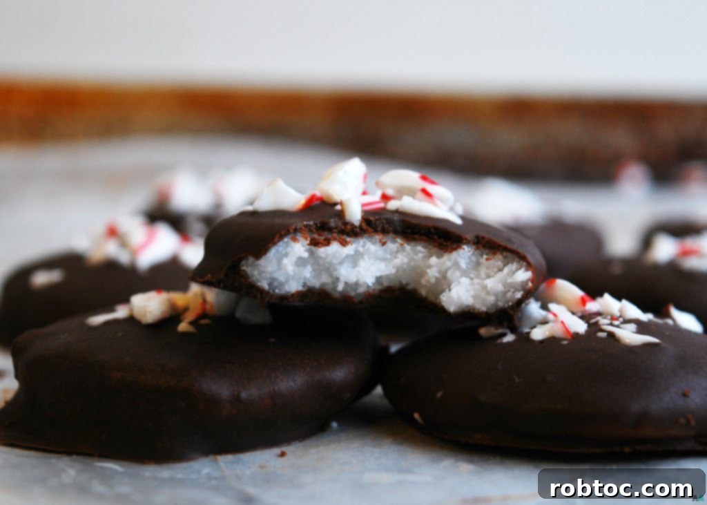 Close-up of Dairy-free Homemade Peppermint Patties with crushed candy canes, suitable for gluten-free, dairy-free, egg-free, soy-free, peanut-free, tree nut-free, top 8 free, and vegan diets.