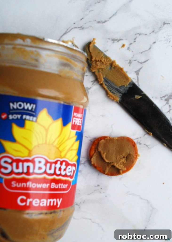 Top Allergen-Free Vegan No-Bake Chocolate Pretzel Bites 5 Step 2: Placing a halved vegan marshmallow on top of the SunButter-coated pretzel.