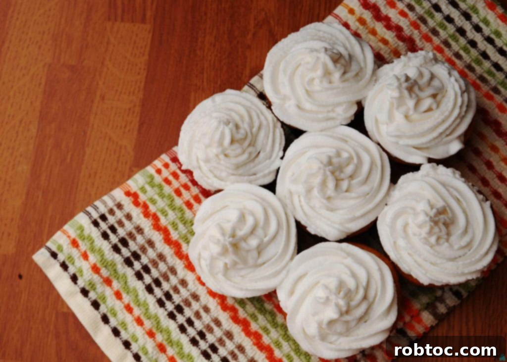 Piped dairy-free vanilla frosting on an un-decorated surface, ready for cupcakes or cake