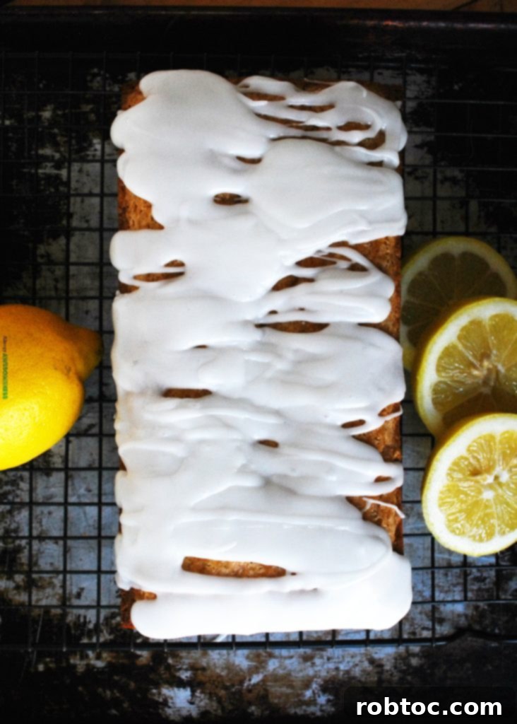 Sunshine Lemon Loaf with Tangy Glaze: Vegan & Top 8 Allergen-Friendly 3 Close-up of a slice of allergy-friendly lemon loaf on a plate, showing its soft crumb and glaze