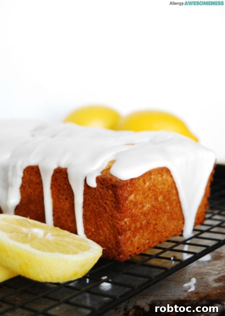 Sunshine Lemon Loaf with Tangy Glaze: Vegan & Top 8 Allergen-Friendly 5 Stack of lemon bread slices with glaze, showcasing the moist texture and inviting appeal