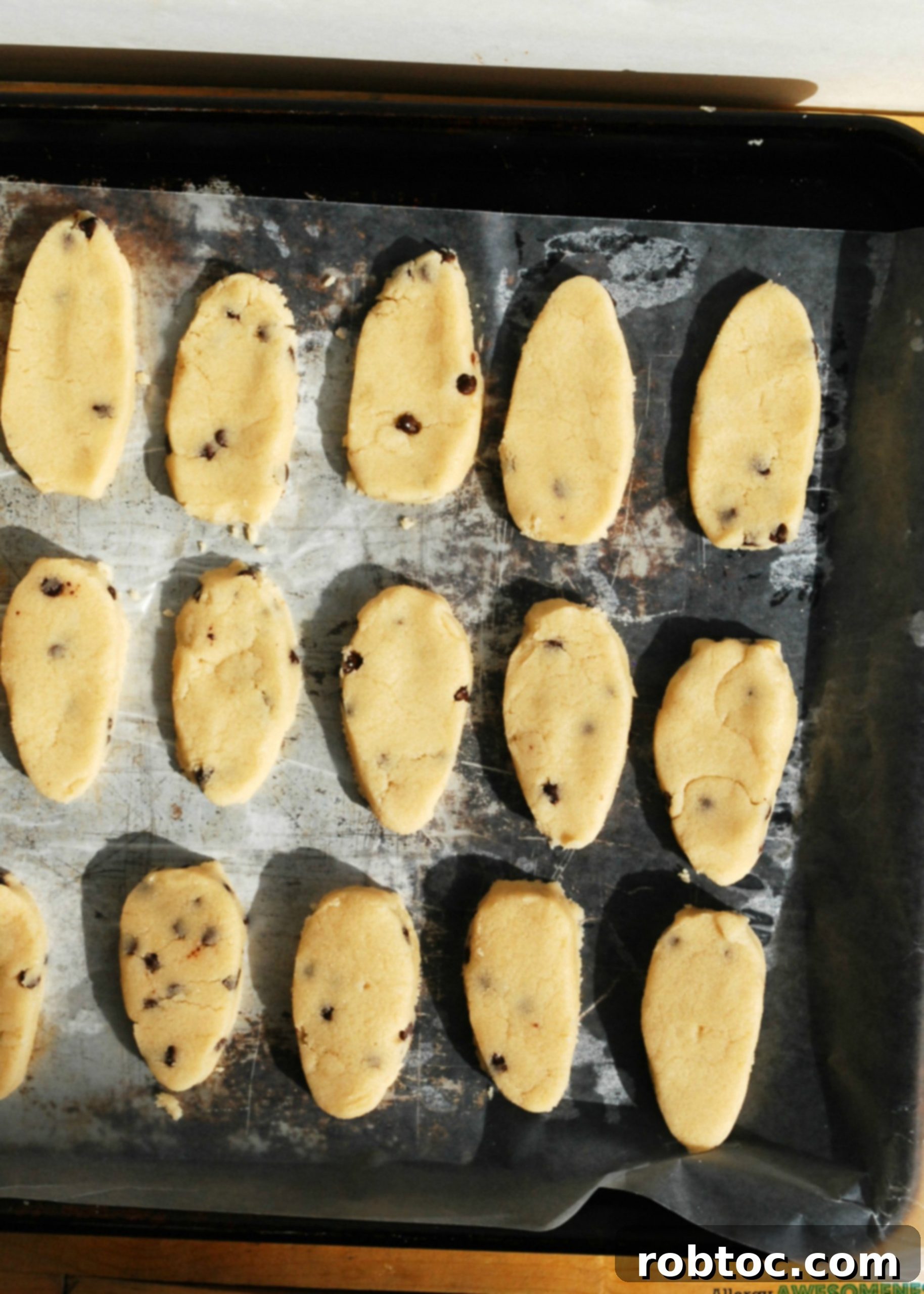 Close up of edible cookie dough shaped into an egg, highlighting its texture.