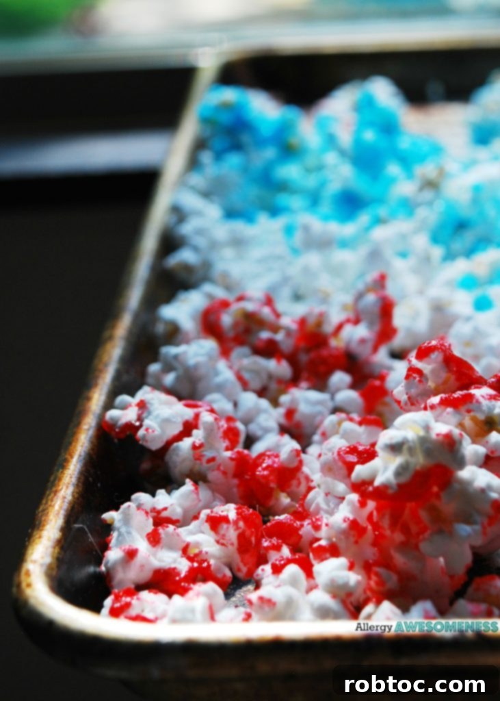 Red White and Blue Popcorn: 3 Easy Ingredients, Allergy Safe 3 Close-up of vibrant 4th of July Popcorn, showcasing the red, white, and blue colors, in a festive bowl.