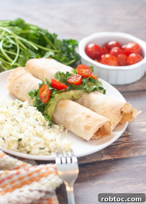 Ultimate Gluten Free Baked Chicken Taquitos 2 gluten-free baked chicken taquitos with black bean filling