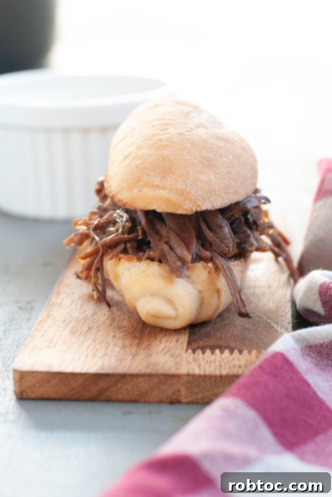 gluten free french dip sandwich on a cutting board