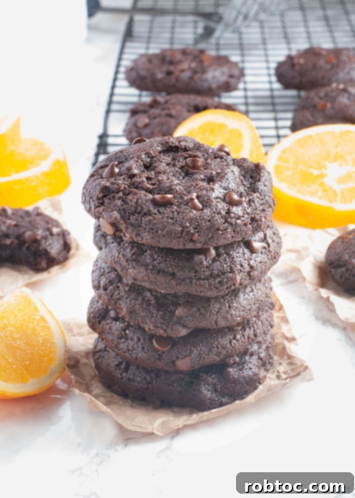 Indulgent Gluten Free Vegan Chocolate Orange Cookies Top 8 Allergen Free 2 Soft gluten-free dairy-free chocolate orange cookies stacked with fresh orange slices