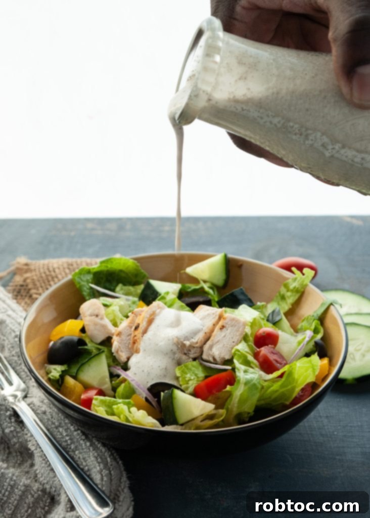 Vibrant Vegan Greek Salad with Creamy Tzatziki 2 Fresh Greek Salad with homemade vegan Tzatziki dressing drizzled over it, showing vibrant vegetables and grilled chicken