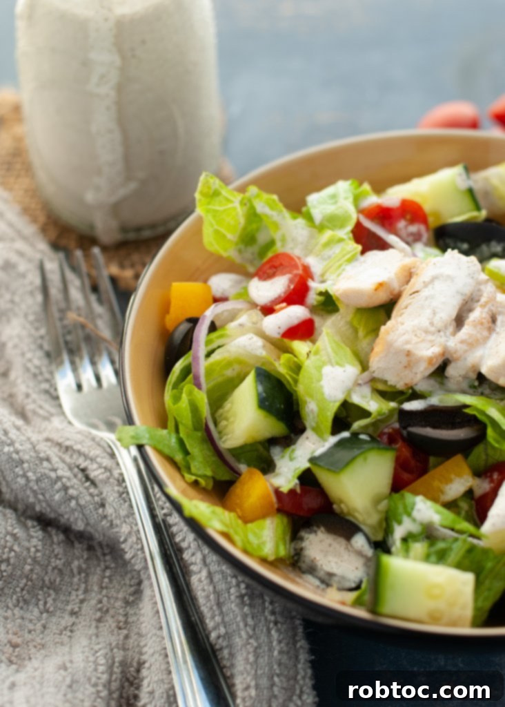 Vibrant Vegan Greek Salad with Creamy Tzatziki 3 A close-up of the vegan Greek salad with tzatziki sauce, showcasing the texture and vibrant colors of the ingredients.