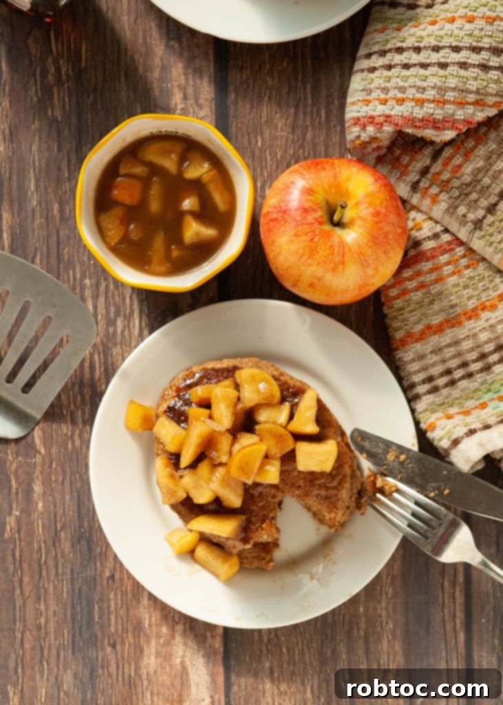 Rustic Spiced Apple Oatmeal Pancakes with fresh apple slices, perfect for a fall breakfast.