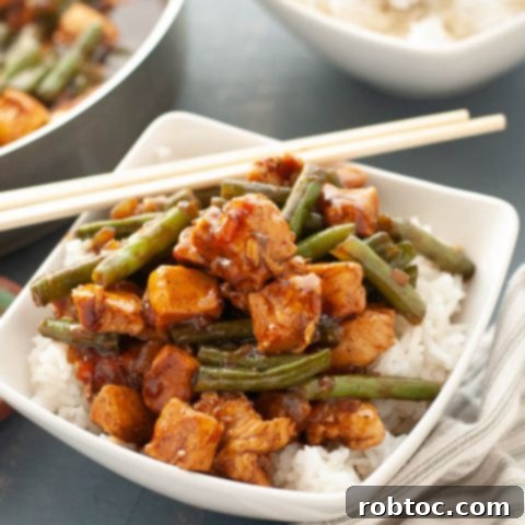 Gluten-Free Black Pepper Chicken recipe served with rice and chopsticks