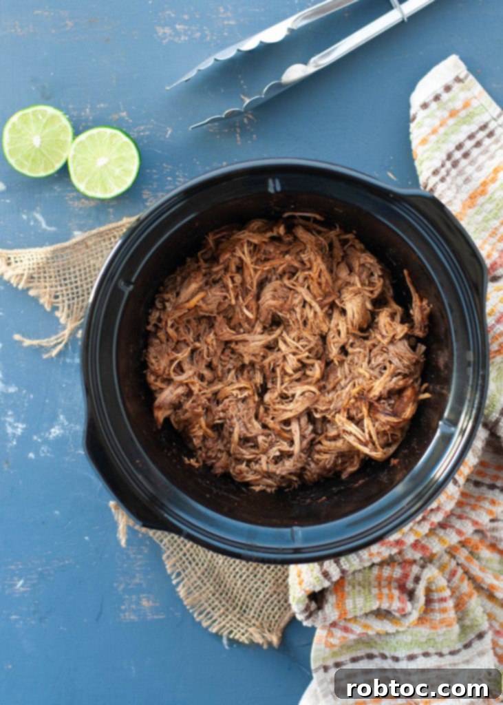 crock-pot-pork-taco-recipe with shredded pork ready to serve