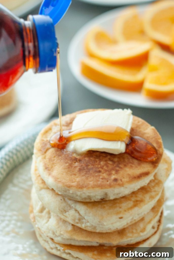 gluten-free-vegan-pancake-stack-with-syrup-being-poured