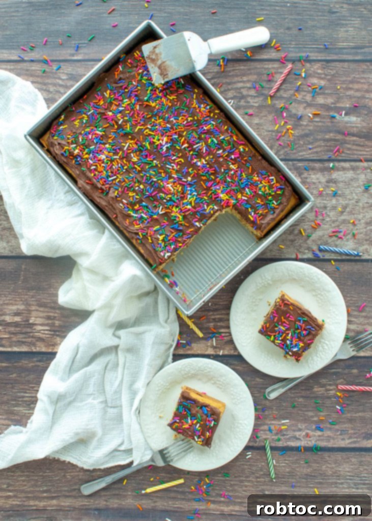 Top-down shot of a gluten-free vegan yellow cake in a pan with several slices already removed.
