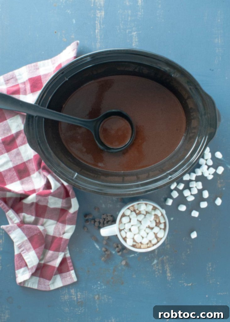 Close-up of creamy dairy-free crock pot hot chocolate in a mug with marshmallows.