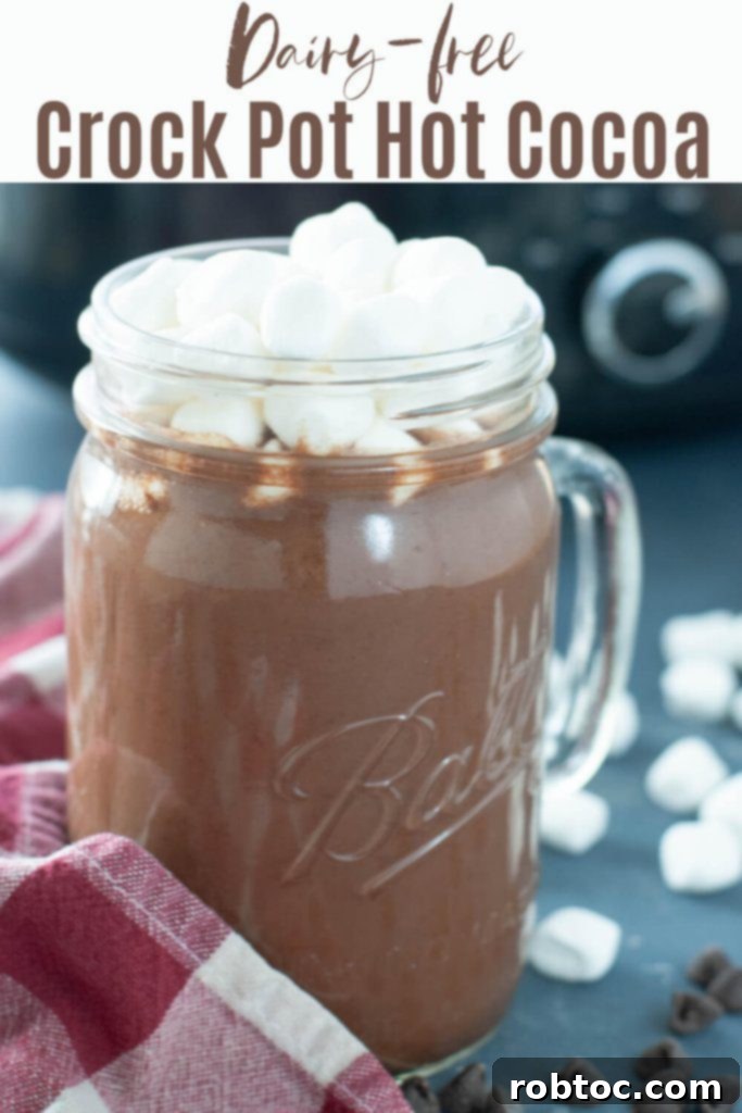 A festive holiday mug of allergy-friendly hot cocoa topped with marshmallows, perfect for cozy winter days.