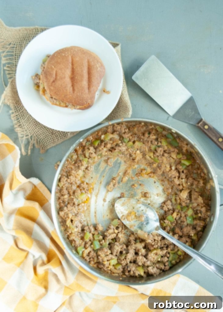 gluten-free-dairy-free-philly-cheesesteak-mixture-in-a-skillet-with-a-bun-on-a-plate