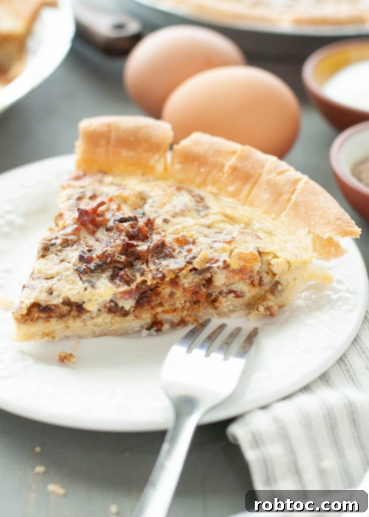one-slice-of-bacon-and-onion-quiche-on-a-white-plate