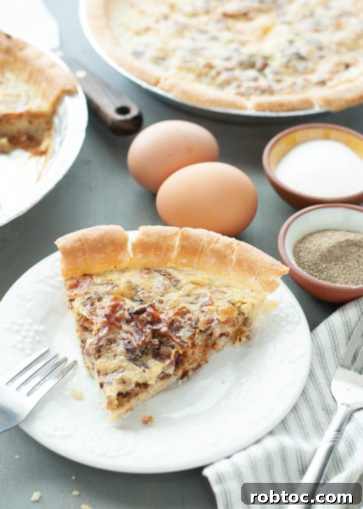 one-slice-of-bacon-and-onion-quiche-with-the-pie-behind-it