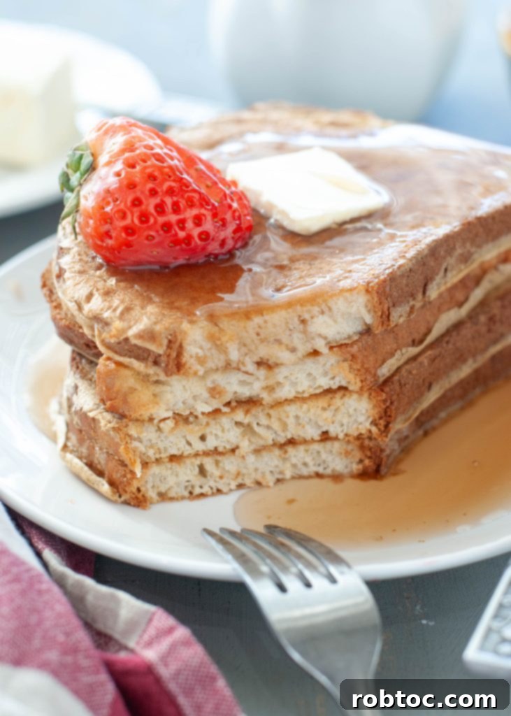 High-Protein Gluten-Free Dairy-Free French Toast 5 large-stack-of-gluten-free-dairy-free-protein-french-toast-with-a-bite-taken-out-of-it