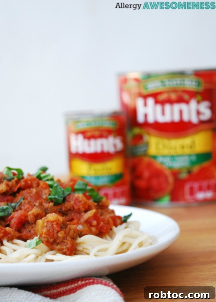 Slow Cooker Bolognese: Made for Everyone 6 A collection of ingredients, including Hunt's tomato cans, ready for slow cooker bolognese preparation.