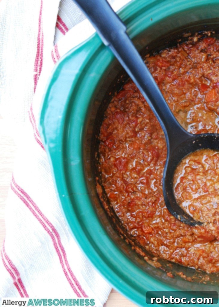 Slow Cooker Bolognese: Made for Everyone 10 The slow cooker filled with simmering bolognese sauce, ready to serve.