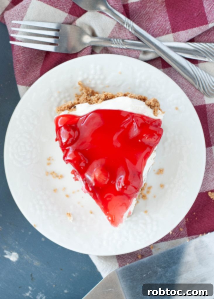a close up above a single slice of a no-bake-cherry-cheesecake that is milk free