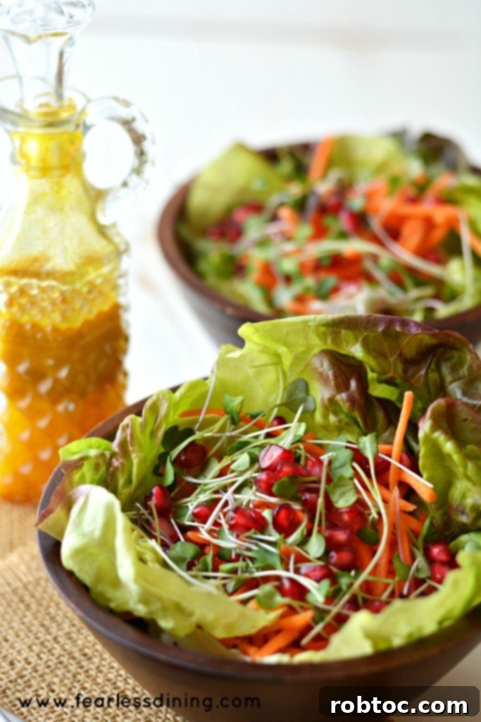 Butter Leaf, Sprout, Carrot & Pomegranate Salad with Turmeric Vinaigrette - A colorful and nutrient-dense salad.