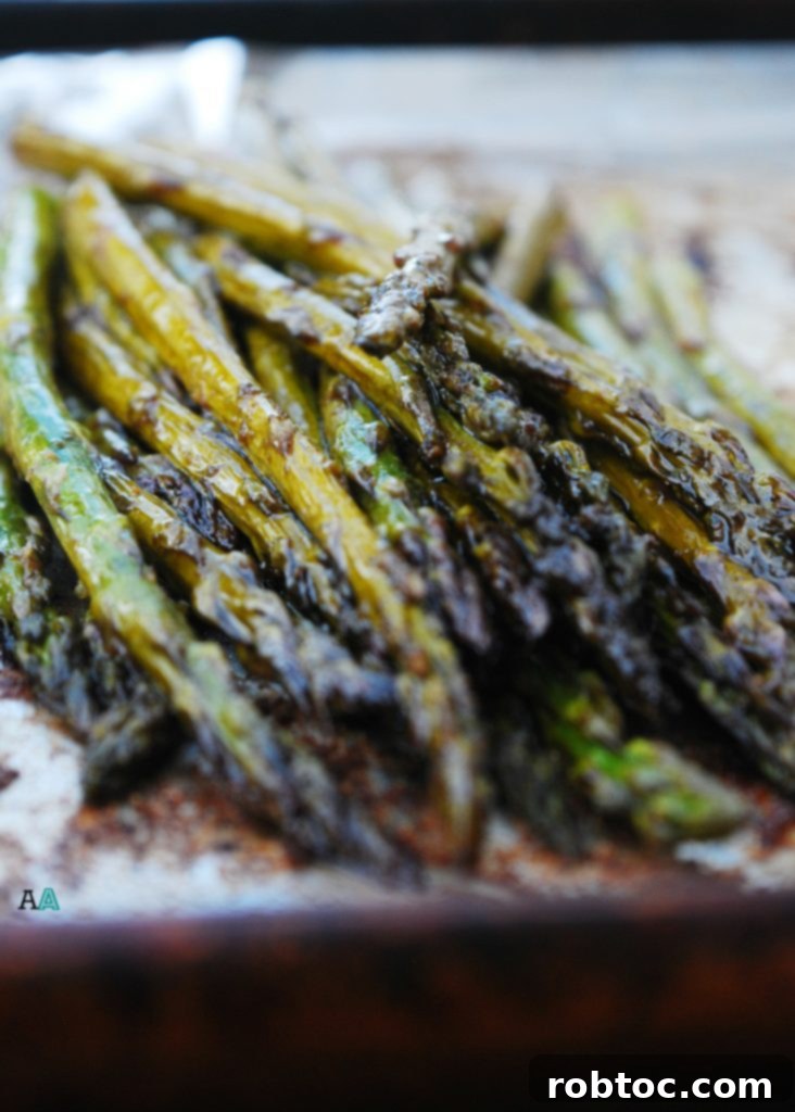 Caramelized Balsamic Garlic Roasted Asparagus 2 Perfectly Roasted Garlic Balsamic Asparagus Spears on a Baking Sheet
