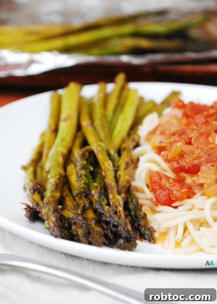 Caramelized Balsamic Garlic Roasted Asparagus 3 Close-up of Roasted Garlic Balsamic Asparagus on a White Plate