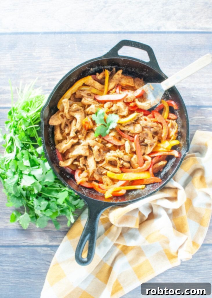 overhead-shot-of-chicken-fajitas-in-cast-iron-skillet