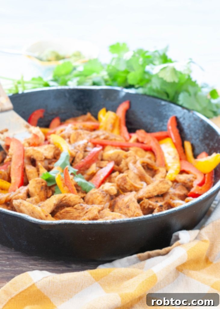 chicken-bell-peppers-and-onions-cooked-in-fajita-marinade-in-a-cast-iron-skillet