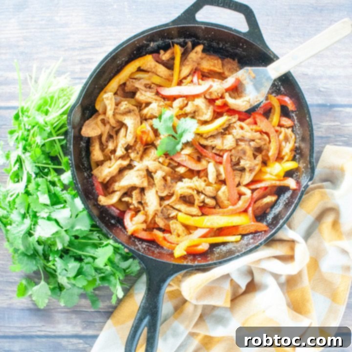 overhead-shot-of-chicken-fajitas-in-cast-iron-skillet