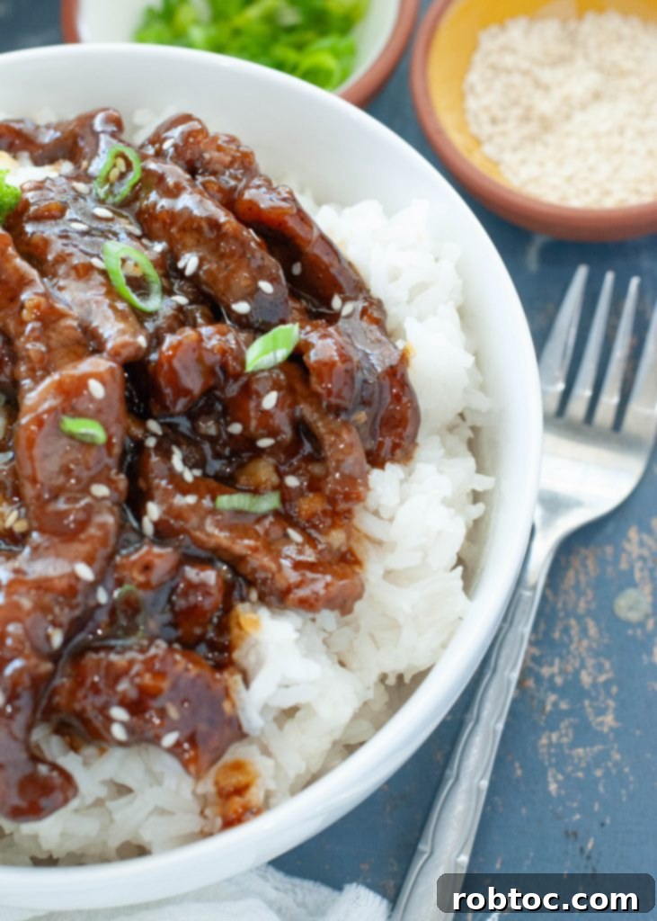Effortless Homemade Beef Teriyaki 2 close up of beef teriyaki over rice in a white bowl