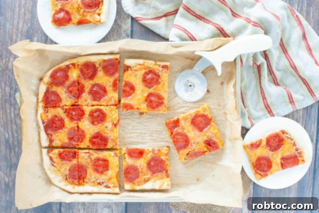 Gluten-free pizza from above with slices missing in a rectangle shape, showing cheesy toppings and golden crust