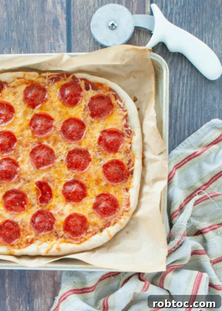 Half of a golden-brown gluten-free pizza from above, showcasing its texture and ready-to-eat appeal