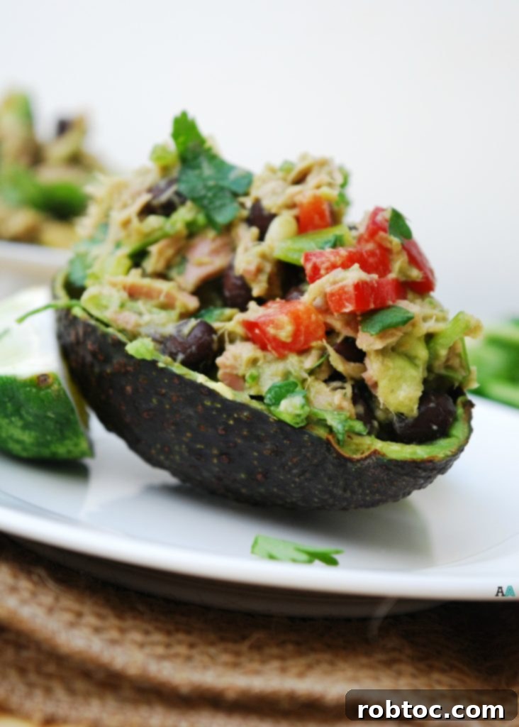 Delicious and vibrant Mexican Tuna Salad served in an avocado half, highlighting its allergy-friendly and grain-free nature.