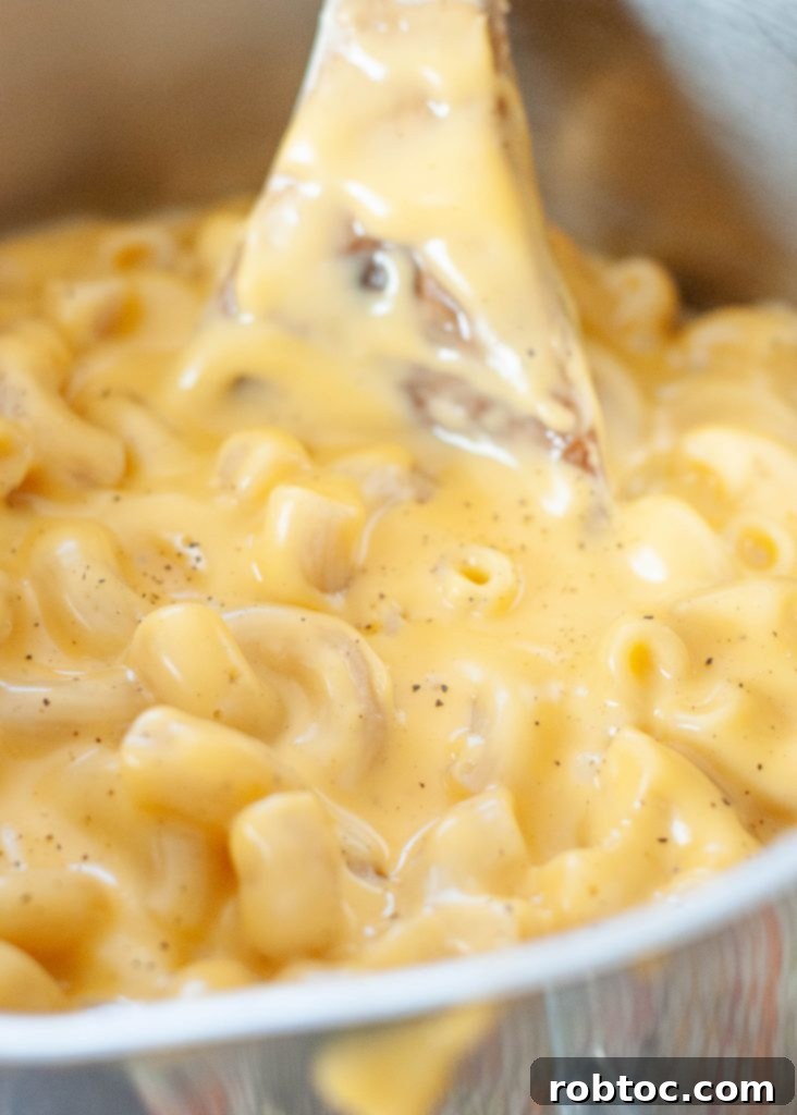 how-to-make-macaroni-and-cheese-gluten-free-close-up-in-pot-with-wooden-spoon
