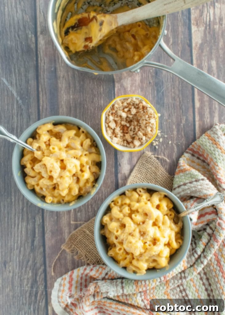 one-empty-pot-with-two-brimming-bowls-of-gluten-free-mac-and-cheese-shot-from-above
