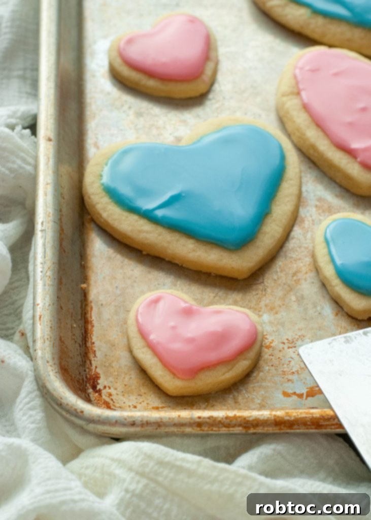 heart-shaped-gluten-free-sugar-cookies-on-the-corner-of-a-baking-sheet
