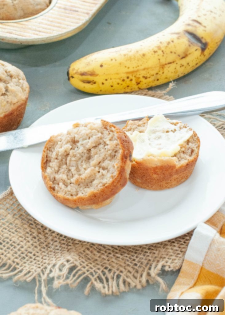 gluten-free-banana-muffin-cut-in-half-with-butter-on-it