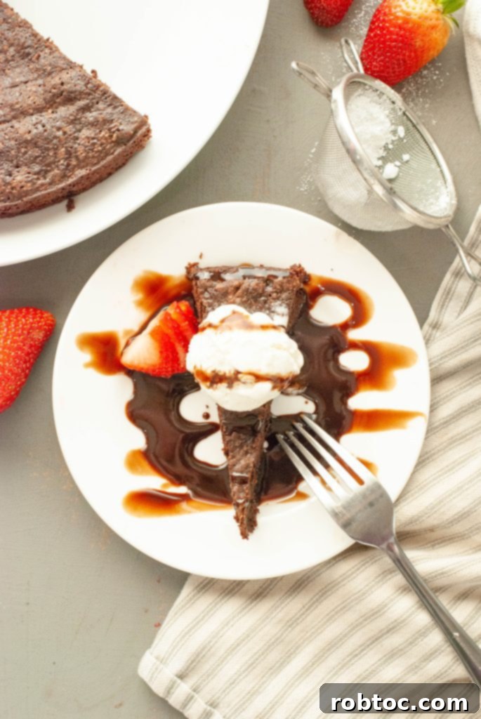 flourless-chocolate-torte-slice-shot-from-above-with-vanilla-ice-cream-and-chocolate-sauce-on-top